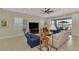 Inviting living room with a large screen television and comfortable seating arrangement at 26636 Irwin Dr, Englewood, FL 34223
