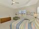Serene bedroom featuring plantation shutters, tray ceilings, and comfortable furniture at 26636 Irwin Dr, Englewood, FL 34223