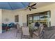 A covered outdoor patio, offering dining and seating areas, perfect for enjoying tranquil moments at 26636 Irwin Dr, Englewood, FL 34223