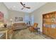 Cozy sitting room with wood accents, comfortable seating and a ceiling fan at 26636 Irwin Dr, Englewood, FL 34223