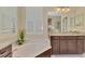 Bright bathroom featuring granite countertops, dual sinks, a soaking tub, and plantation shutters at 27413 Hole In One Pl, Englewood, FL 34223