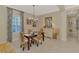 The dining room includes a table, chandelier and view to the entry at 27413 Hole In One Pl, Englewood, FL 34223