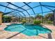 Stunning screened-in pool and spa area with lush landscaping, providing privacy and a tropical oasis at 27413 Hole In One Pl, Englewood, FL 34223