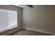 Bedroom featuring wood-look tile, neutral walls, and a large, bright window at 5055 N Beach Rd # 203, Englewood, FL 34223