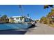 Light blue two story property with palm trees on a sunny day at 5055 N Beach Rd # 203, Englewood, FL 34223