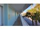 Exterior hallway with blue walls leading to the parking lot at 5055 N Beach Rd # 203, Englewood, FL 34223