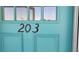 Close up of the front door with the number 203 in black at 5055 N Beach Rd # 203, Englewood, FL 34223