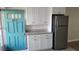Kitchen with stainless steel refrigerator, granite counters and white cabinets, adjacent to front door at 5055 N Beach Rd # 203, Englewood, FL 34223