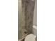 Shower featuring glass door and tile surround with shower head and grab bar at 5055 N Beach Rd # 203, Englewood, FL 34223