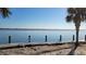 Wooden pier at the water with a life preserver hanging from the side at 5055 N Beach Rd # 203, Englewood, FL 34223