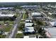 Overhead aerial view shows a home in relation to a street, neighborhood and shopping area at 6347 Oriole Blvd, Englewood, FL 34224