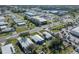 Aerial neighborhood view shows a blue home in a sunny area near shops and businesses at 6347 Oriole Blvd, Englewood, FL 34224