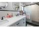Bathroom featuring double sink vanity, modern fixtures, and walk-in shower at 6347 Oriole Blvd, Englewood, FL 34224