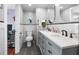 Modern bathroom featuring a double sink vanity, tile floors, and stylish mirrors at 6347 Oriole Blvd, Englewood, FL 34224