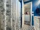 Modern bathroom featuring stylish black and white tile floors and blue accent walls at 6347 Oriole Blvd, Englewood, FL 34224