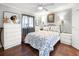 Comfortable bedroom features ceiling fan, natural light and hardwood floors at 6347 Oriole Blvd, Englewood, FL 34224
