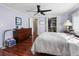 Bedroom showcasing hardwood floors, dresser and access to closet space at 6347 Oriole Blvd, Englewood, FL 34224