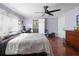 Spacious bedroom with hardwood floors, a ceiling fan, and a view into a connected workspace and bathroom at 6347 Oriole Blvd, Englewood, FL 34224