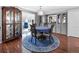 Cozy dining area with hardwood floors, a blue area rug, and a china cabinet for elegant dining experiences at 6347 Oriole Blvd, Englewood, FL 34224