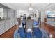 Dining room with a round table, wicker chairs, and modern light fixtures. Adjacent to an updated kitchen at 6347 Oriole Blvd, Englewood, FL 34224