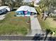 Eye-level exterior view showing well-maintained landscaping, carport, and attractive facade at 6347 Oriole Blvd, Englewood, FL 34224