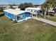 Charming blue home with a well-manicured lawn, covered parking, and an American flag at 6347 Oriole Blvd, Englewood, FL 34224