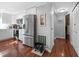 Well-lit kitchen featuring stainless steel appliances, white cabinets, and hardwood flooring at 6347 Oriole Blvd, Englewood, FL 34224