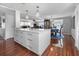 Kitchen island with a marble countertop, ample storage, and stylish pendant lighting at 6347 Oriole Blvd, Englewood, FL 34224
