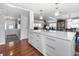 Open concept kitchen with a large island featuring a countertop, ample storage, and modern pendant lighting at 6347 Oriole Blvd, Englewood, FL 34224