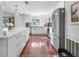 Bright kitchen featuring stainless steel appliances, a large island, and sleek white cabinetry at 6347 Oriole Blvd, Englewood, FL 34224