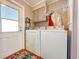 Functional laundry room with modern appliances and exterior access at 6347 Oriole Blvd, Englewood, FL 34224