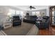 Comfortable living room with black leather furniture and a neutral patterned rug beneath a ceiling fan at 6347 Oriole Blvd, Englewood, FL 34224