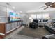 Relaxing living room with built-in storage, a large TV, and comfortable seating for enjoying home entertainment at 6347 Oriole Blvd, Englewood, FL 34224