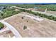 Wide aerial shot of a large lot with several storage units and RVs, backed by lush trees and clear skies at 6522 Coliseum Blvd, Port Charlotte, FL 33981
