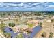 An aerial view showcasing the community's amenities including a pool, tennis courts, and clubhouse at 6522 Coliseum Blvd, Port Charlotte, FL 33981