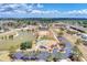 An aerial view of the community's clubhouse, pool, tennis courts, and parking area at 6522 Coliseum Blvd, Port Charlotte, FL 33981