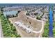 Sprawling aerial view showing the community's layout, with a nearby lake and natural surroundings at 6522 Coliseum Blvd, Port Charlotte, FL 33981