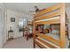 Shared bedroom featuring wooden bunk beds, carpeted floors, and a window, creating a cozy space at 6522 Coliseum Blvd, Port Charlotte, FL 33981
