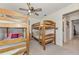 Comfortable bedroom featuring wooden bunk beds and carpeted floors, creating a cozy space at 6522 Coliseum Blvd, Port Charlotte, FL 33981