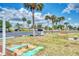 Outdoor space featuring palm trees, benches, and a horseshoe pit for recreational enjoyment at 6522 Coliseum Blvd, Port Charlotte, FL 33981