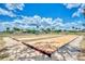 Bocce ball courts with a clear blue sky backdrop with palm trees and clubhouse in the distance at 6522 Coliseum Blvd, Port Charlotte, FL 33981