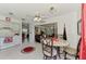 Bright kitchen with white cabinets, tile flooring, dining space, and open access to the living area at 6522 Coliseum Blvd, Port Charlotte, FL 33981