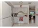 Well-maintained kitchen features white cabinets, appliances, and ample counter space with view to adjacent living room at 6522 Coliseum Blvd, Port Charlotte, FL 33981