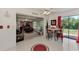 Open living area with tile flooring, slider to Gathering room, dining area and view to the back yard at 6522 Coliseum Blvd, Port Charlotte, FL 33981