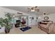 Spacious living room with tile floors, ceiling fans, and sliding glass doors leading to an outdoor area at 6522 Coliseum Blvd, Port Charlotte, FL 33981