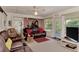 Comfortable living room featuring plush seating, neutral carpet, and access to a screened porch at 6522 Coliseum Blvd, Port Charlotte, FL 33981
