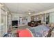 Cozy carpeted living room with fan, TV, comfortable leather seating, and an open floor plan at 6522 Coliseum Blvd, Port Charlotte, FL 33981