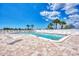 Community pool with a shallow end for lounging and deeper section for swimming, surrounded by landscaping at 6522 Coliseum Blvd, Port Charlotte, FL 33981