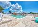 Community pool area with ample seating and a clear view of the pristine water on a sunny day at 6522 Coliseum Blvd, Port Charlotte, FL 33981