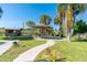 Backyard features a cabana, landscaping, and a stone walkway at 8243 Pinetree Ln, Englewood, FL 34224
